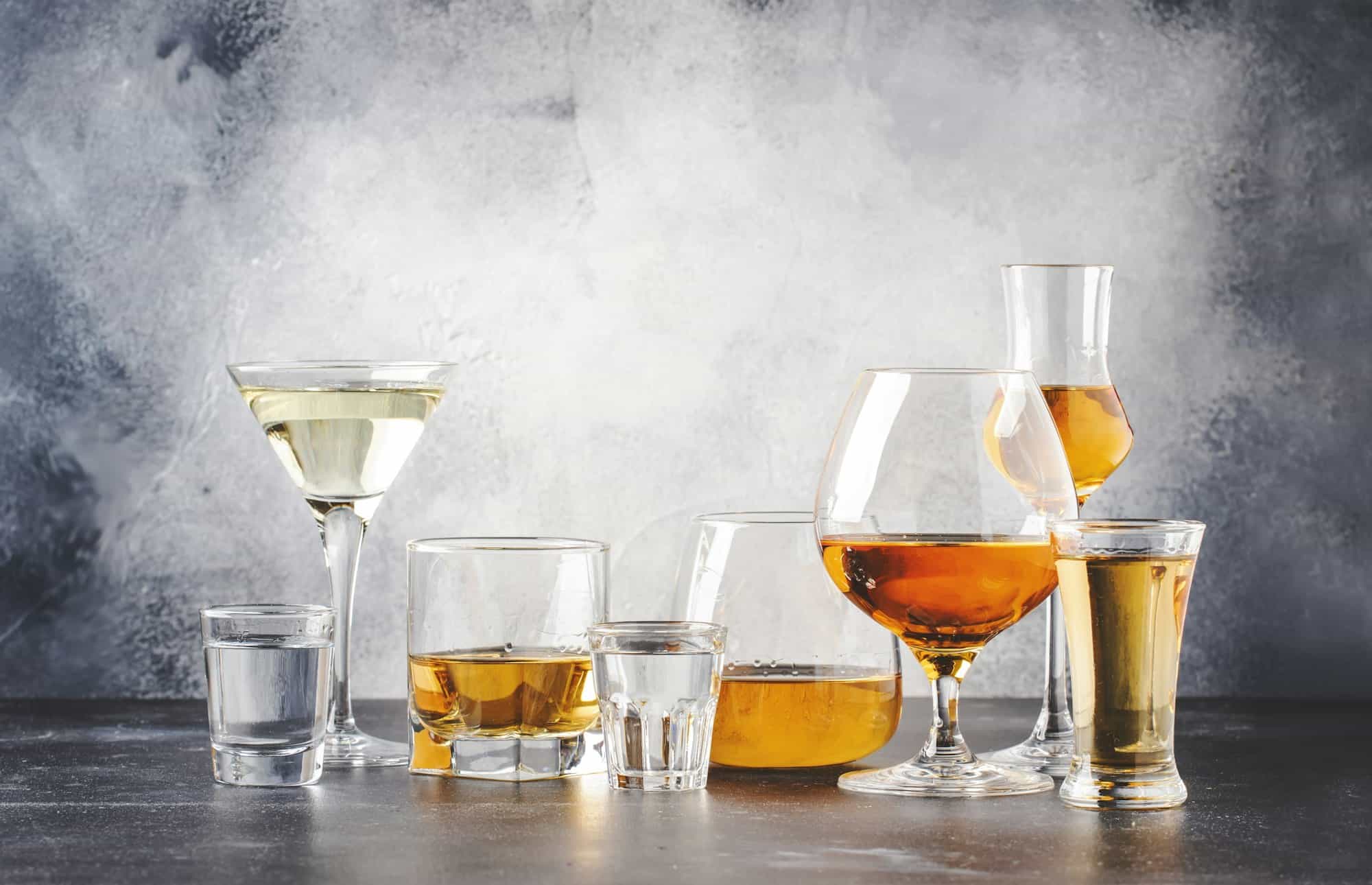 Strong alcoholic drinks in glasses in assortment: vodka, cognac, tequila, brandy and whiskey, grappa